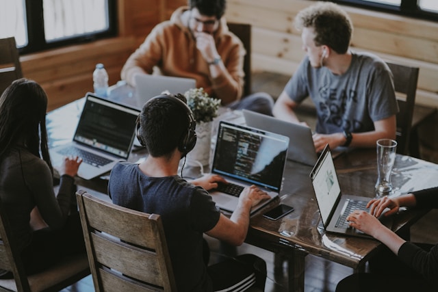 People sitting together with laptops